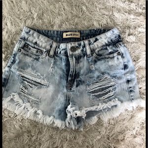 Acid washed ripped denim shorts