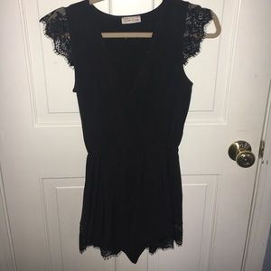 Beautiful black romper with lace trim