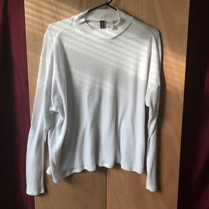 a white, turtle neck, flowy long sleeve shirt