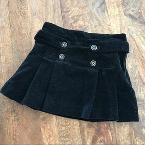 Black velvet pleated skirt with button detail
