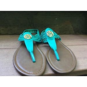 Teal sandals with elastic straps.