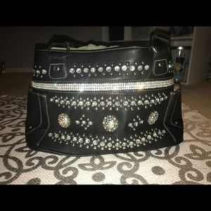 Black handbag with rhinestones detail.