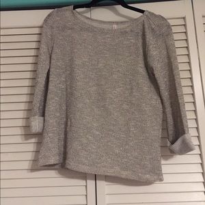 brown/gold shirt with sleeves rolled.