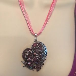 butterfly and a heart on a flower pendant