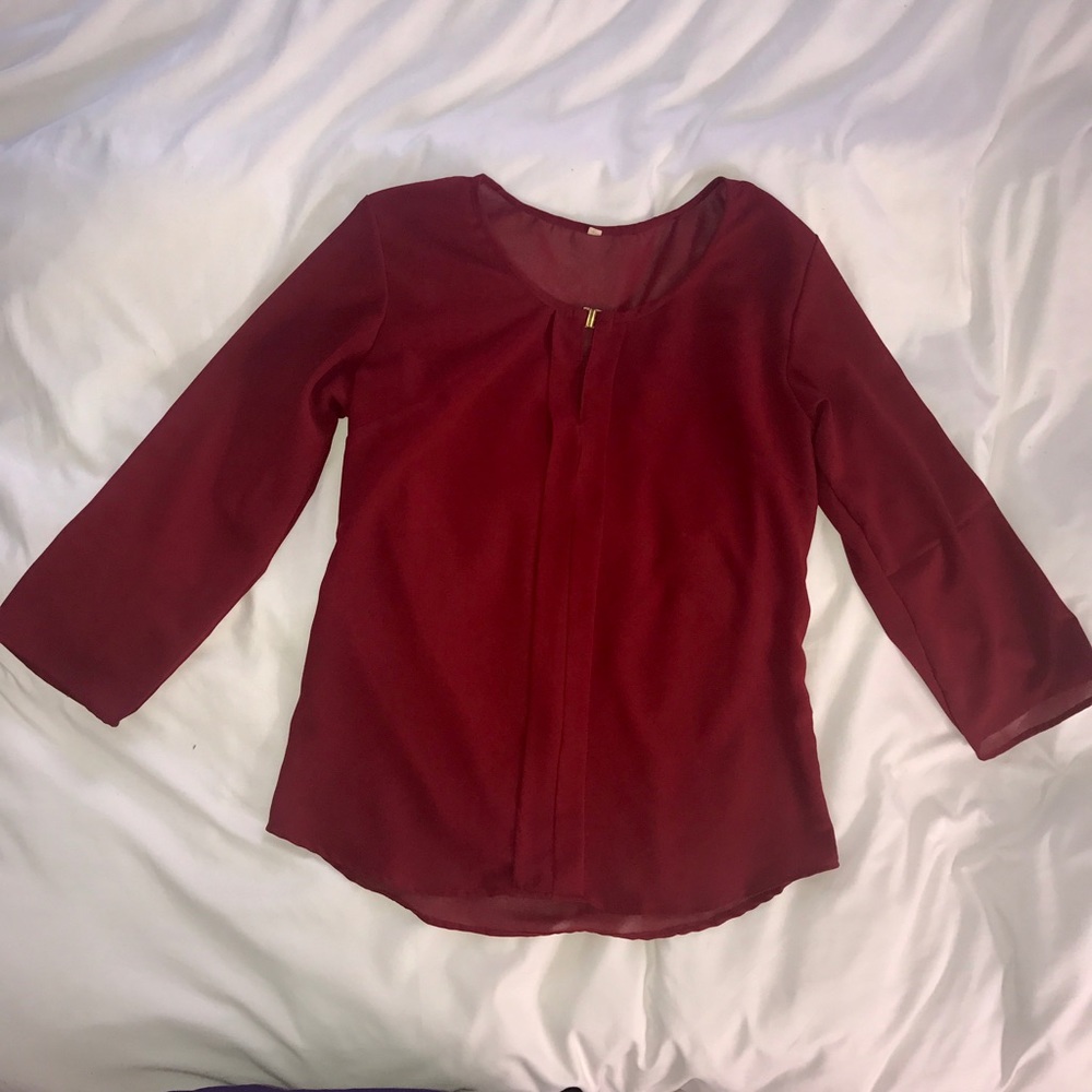 Red blouse with gold clasp
