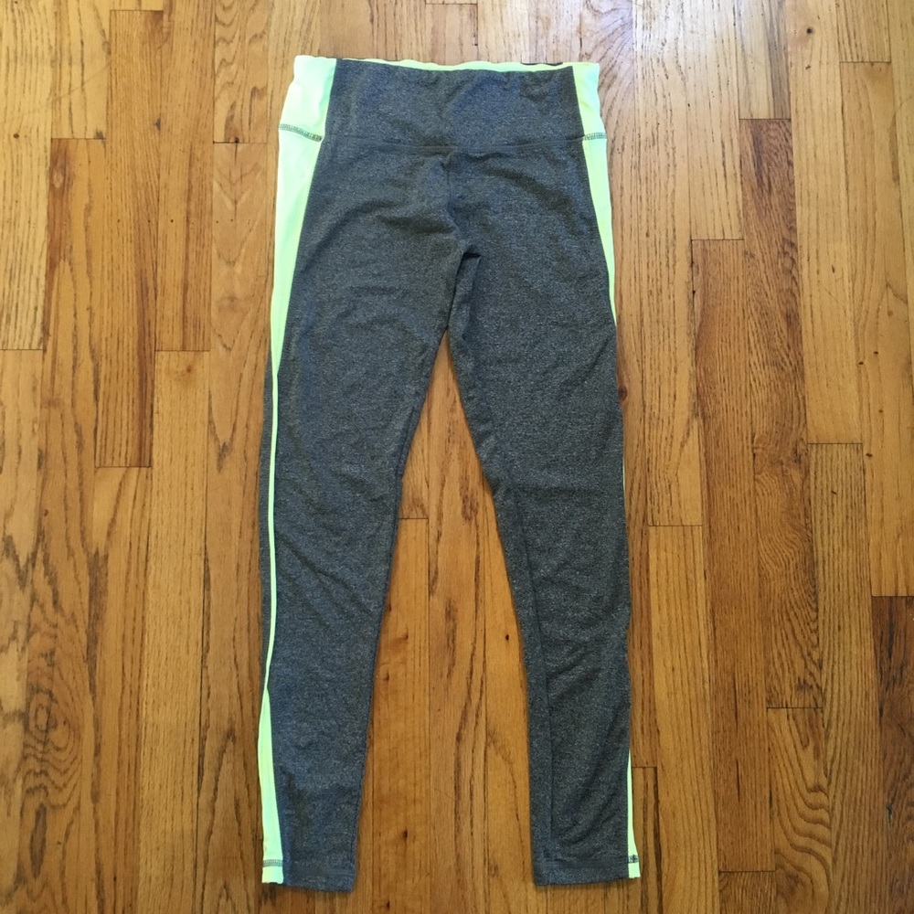Gray athletic leggings with yellow detailing