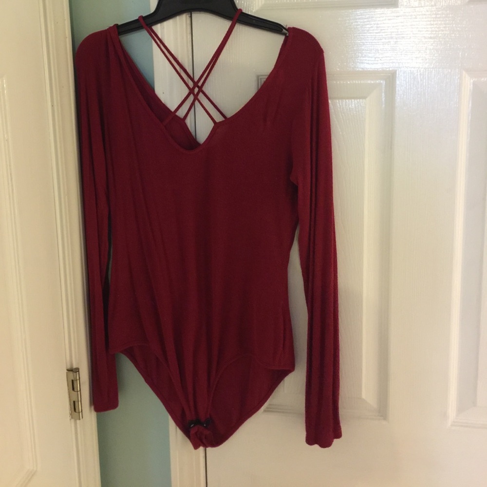 Deep red crisscross body suit.