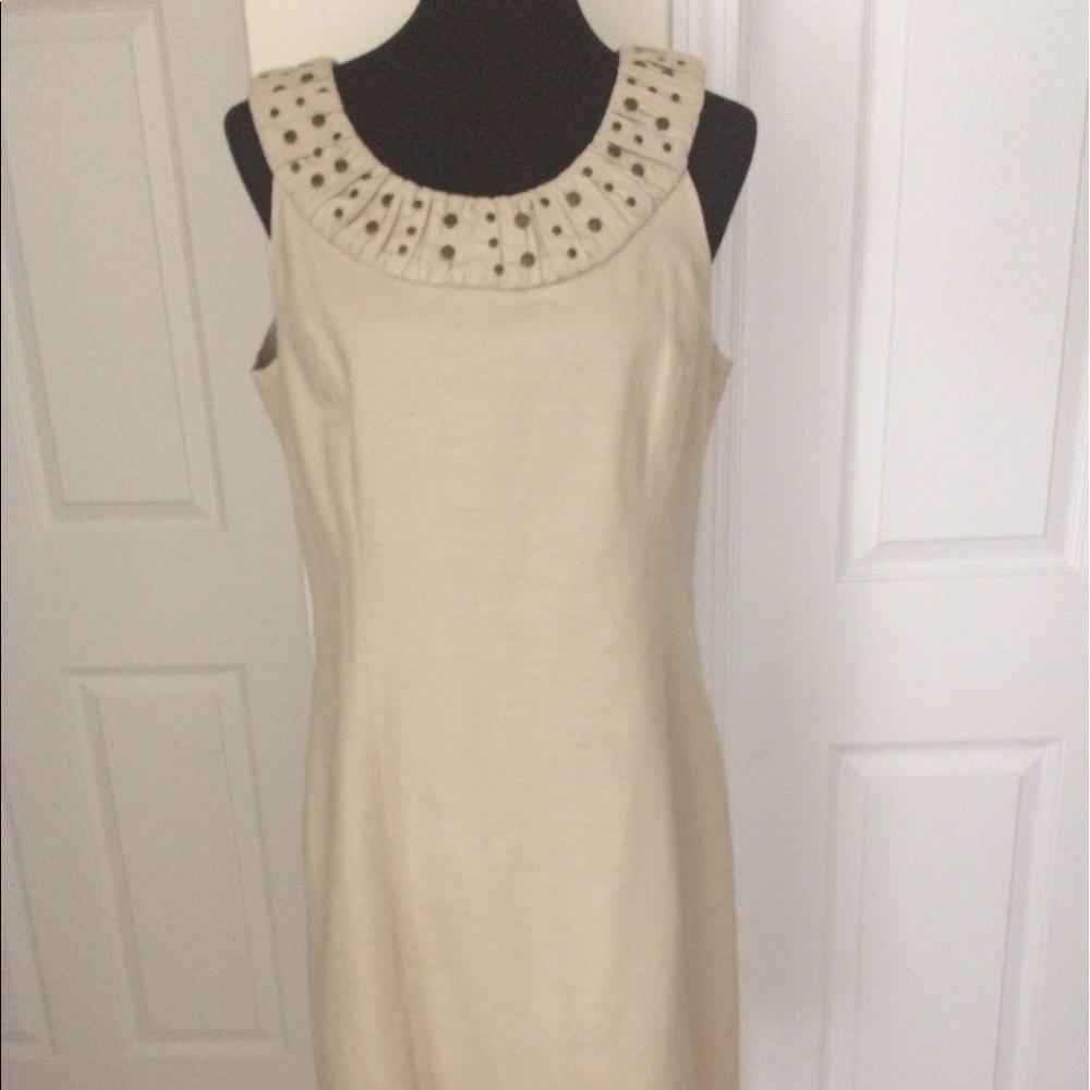 Linen look dress with grommets at neckline.