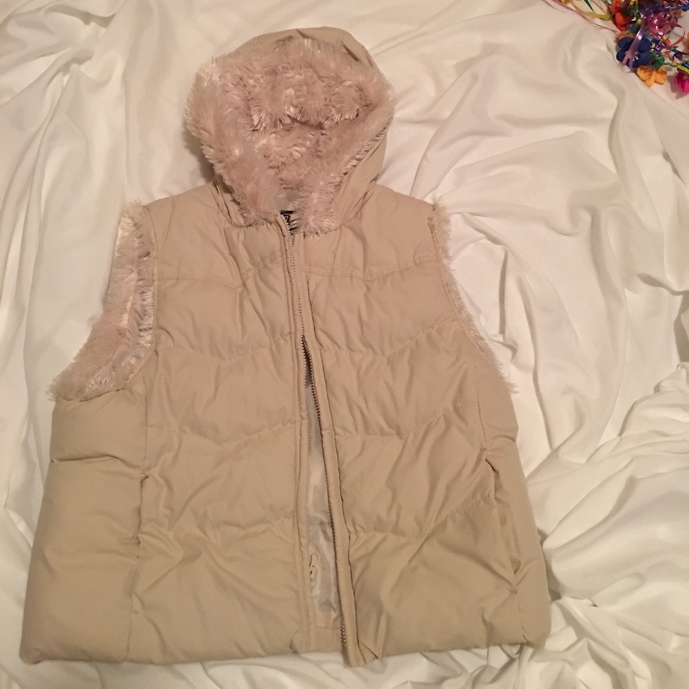 Cream colored, hooded vest.