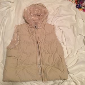 Cream colored, hooded vest.