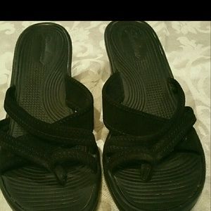 A pair of black Sketcher sandals