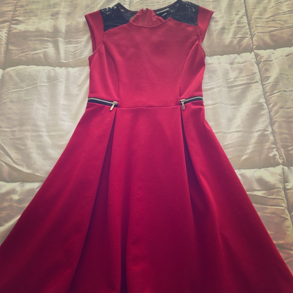 Red dress with black lace sleeves.