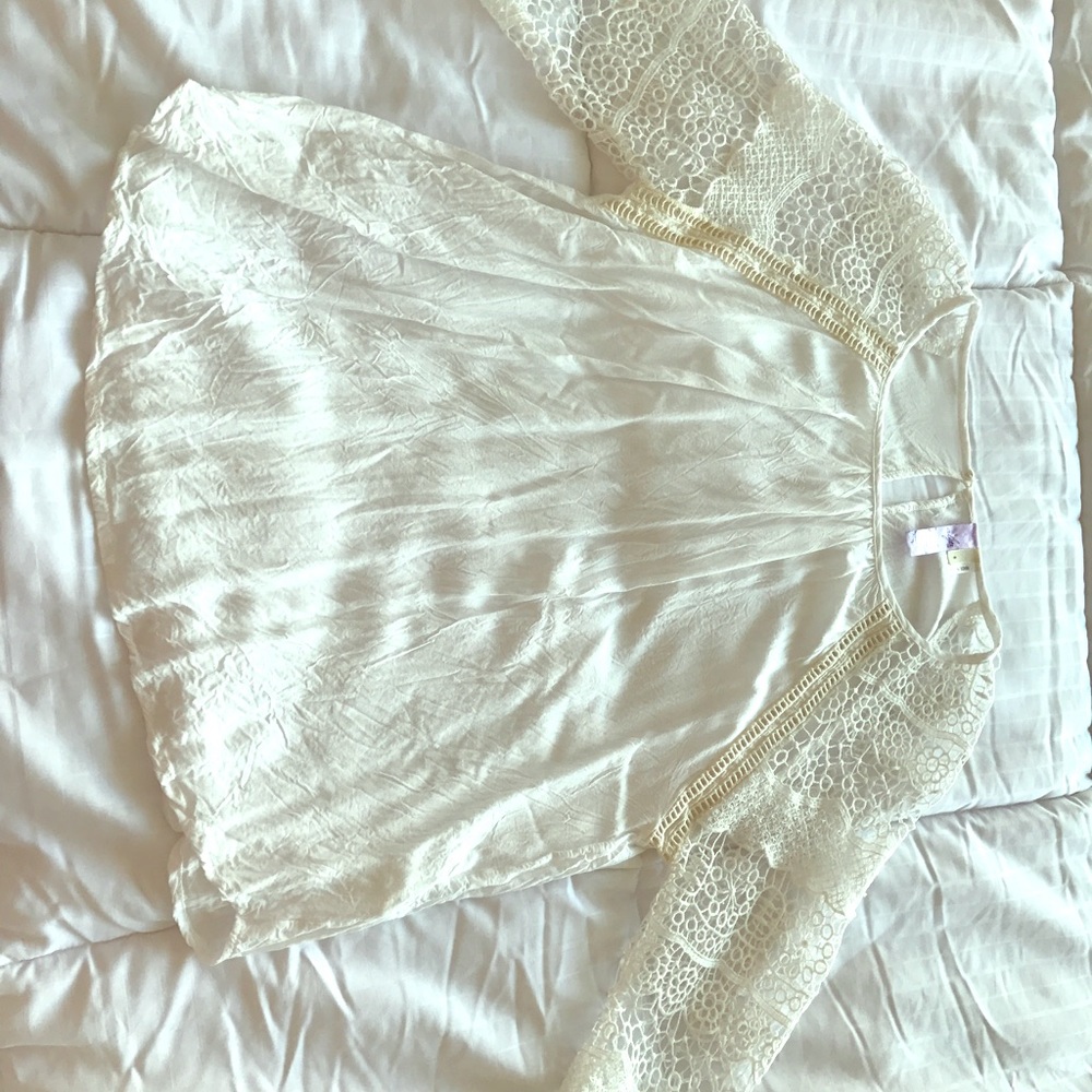 White blouse with cream details.