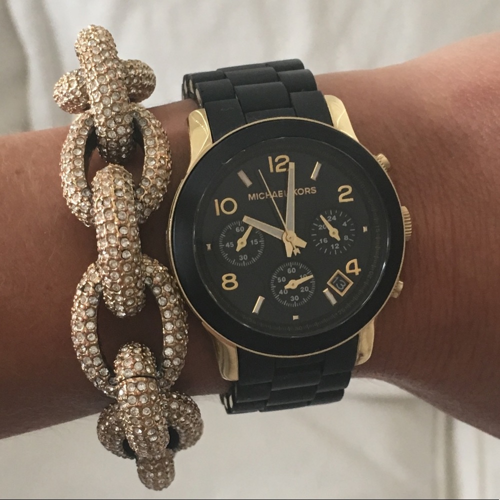 Michael Kors black rubber and gold watch.