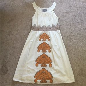 Cream dress with orange accents