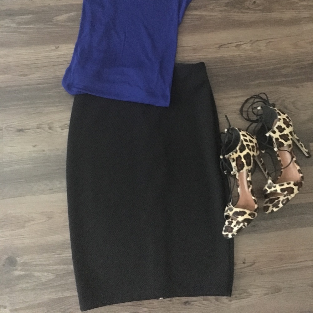 Black fitted midi skirt with exposed zipper.