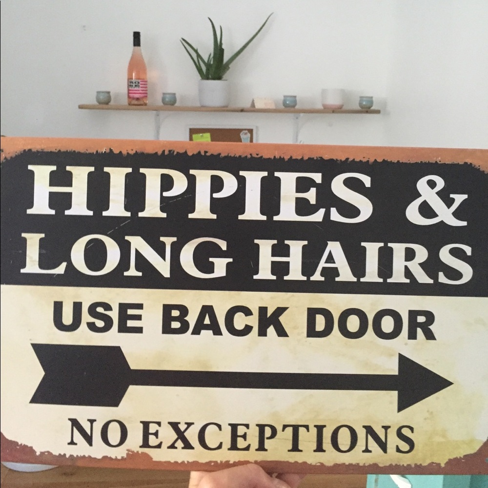"Hippies & Long hairs use back door." Metal sign