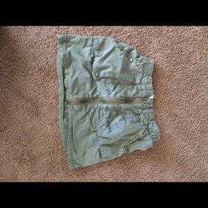 Green mini skirt with detailing.