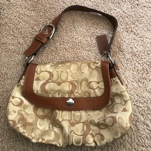 Tan monogram Coach shoulder bag.