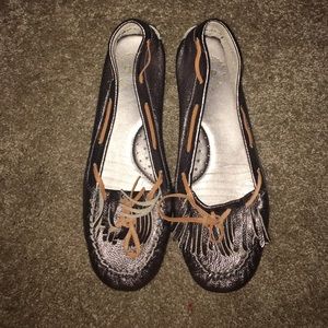 Silver flats with fringe at the toes.