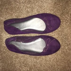 Purple flats with bows at the front.