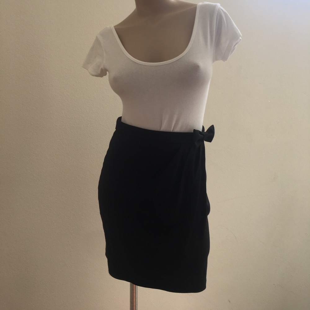 Bow tie draped black skirt.