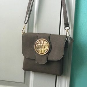 A gray crossbody purse