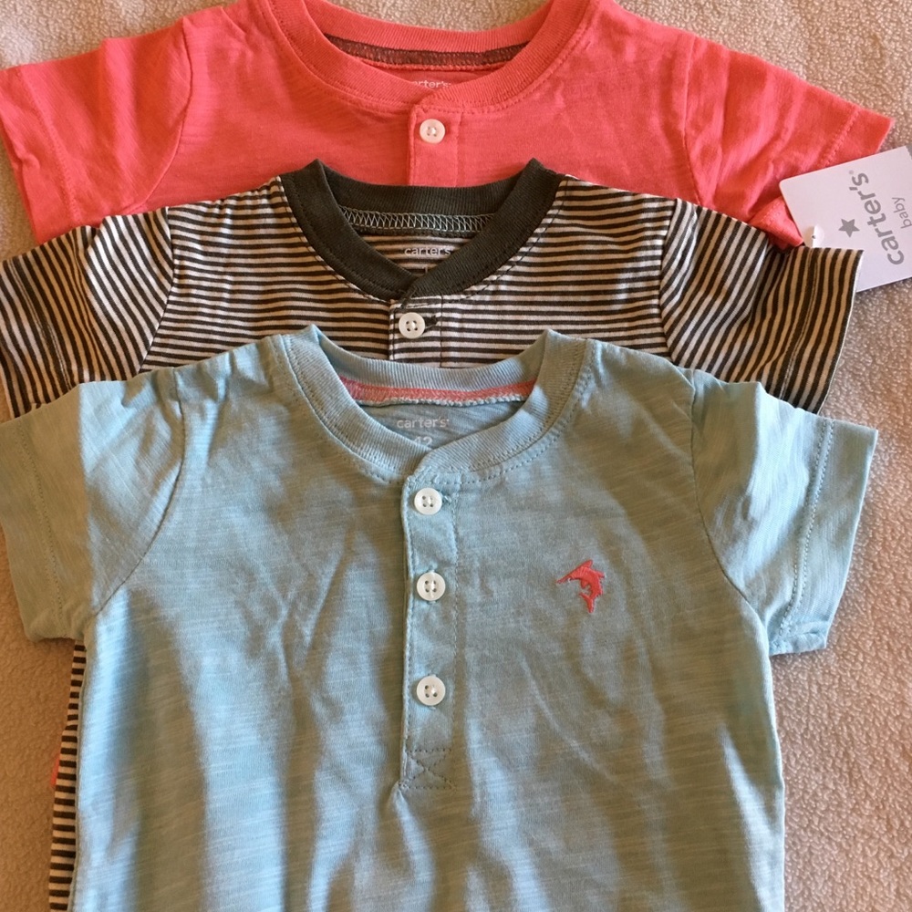 Pack of three short-sleeved Carter's 12M onesies.
