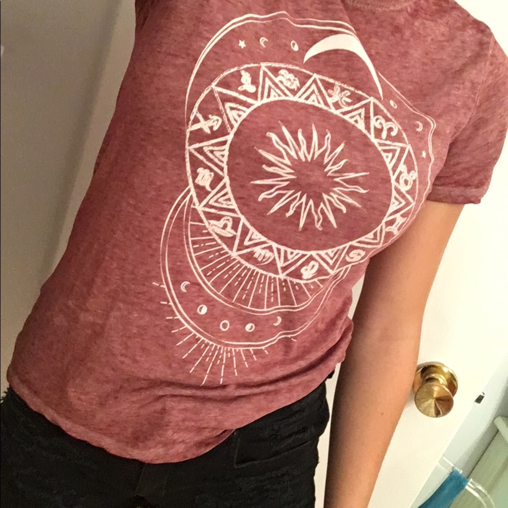 Purple graphic tee with moon and sun design