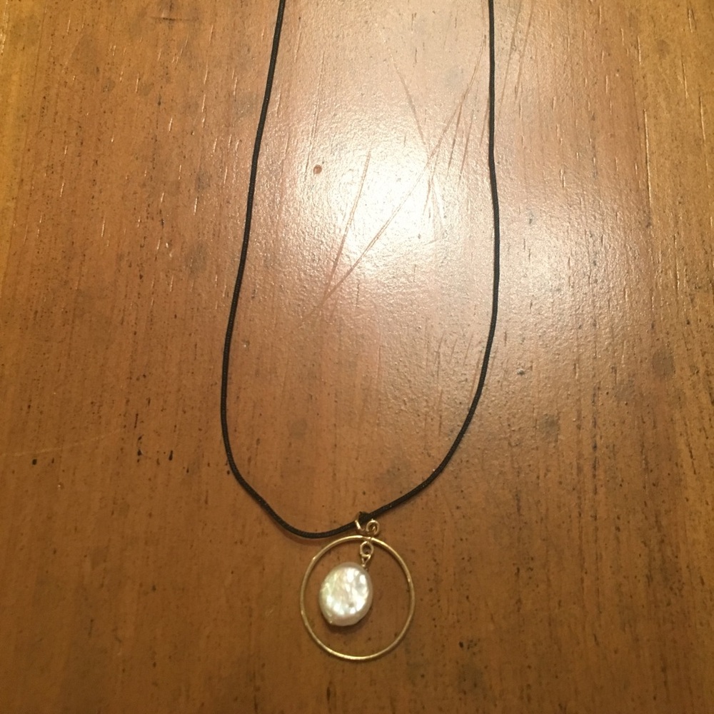 Pearl in gold ring necklace