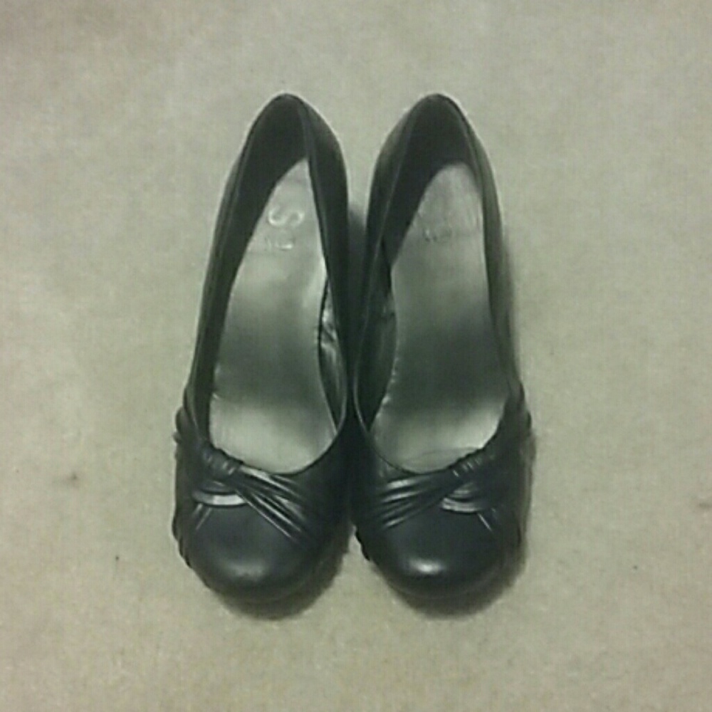 A pair of black high heel dress shoes