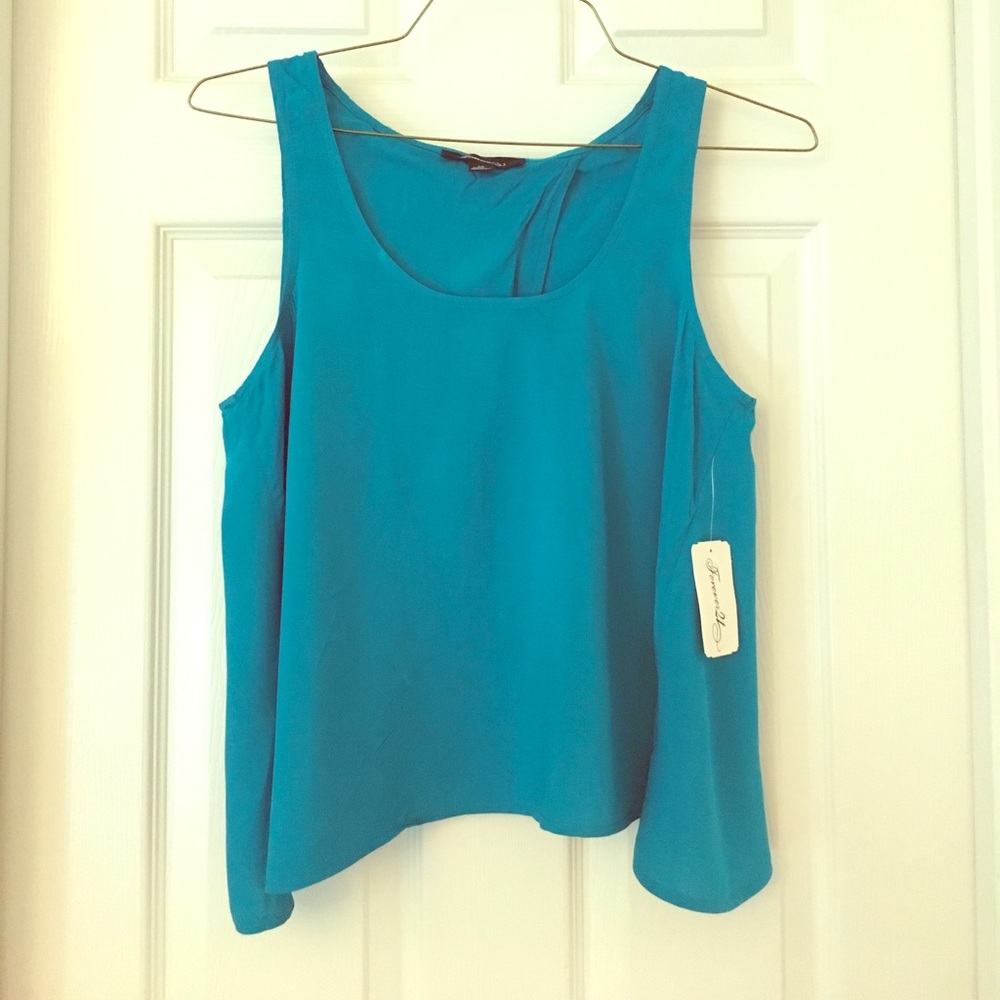 Blue tank top with open back. NWT