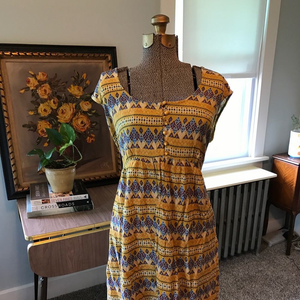 Ochre dress with geometric pattern.
