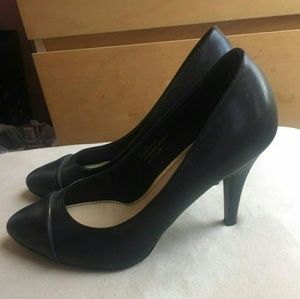 Black pointed toe pumps with gold lining