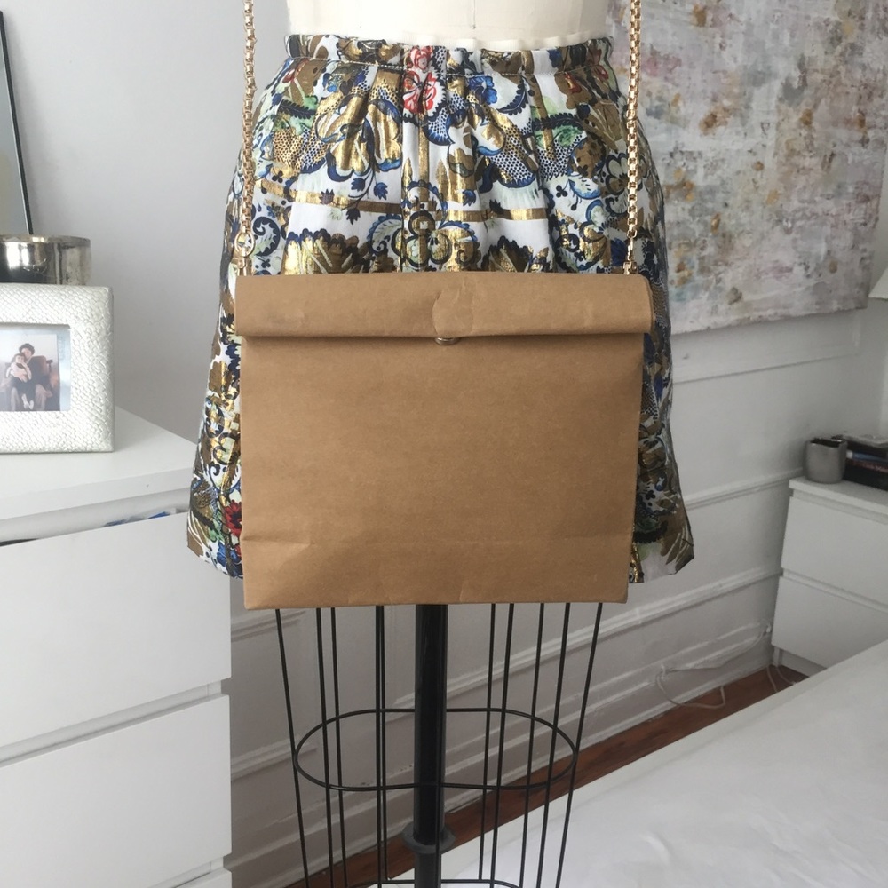 Paper handbag with gold hardware.