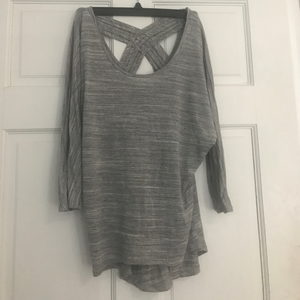 Grey 3/4 sleeve shirt with open back design.