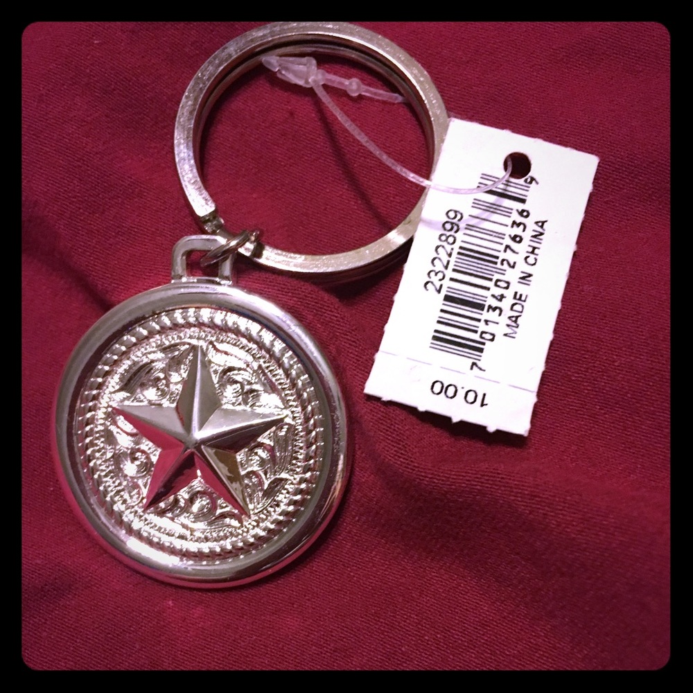 Silver keychain. NWT. Silver with a star on front