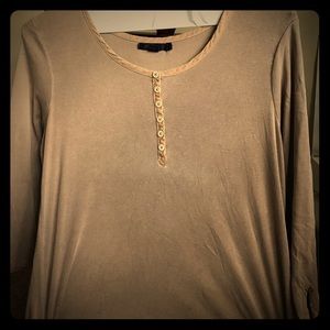 A halfway button up light tan kind sleeved tee