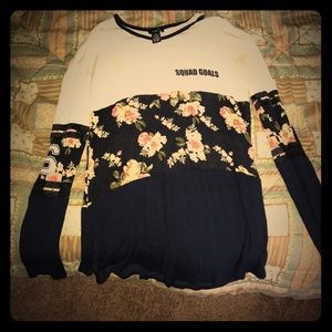 A white, blue "squad goals" floral Long sleevedtee