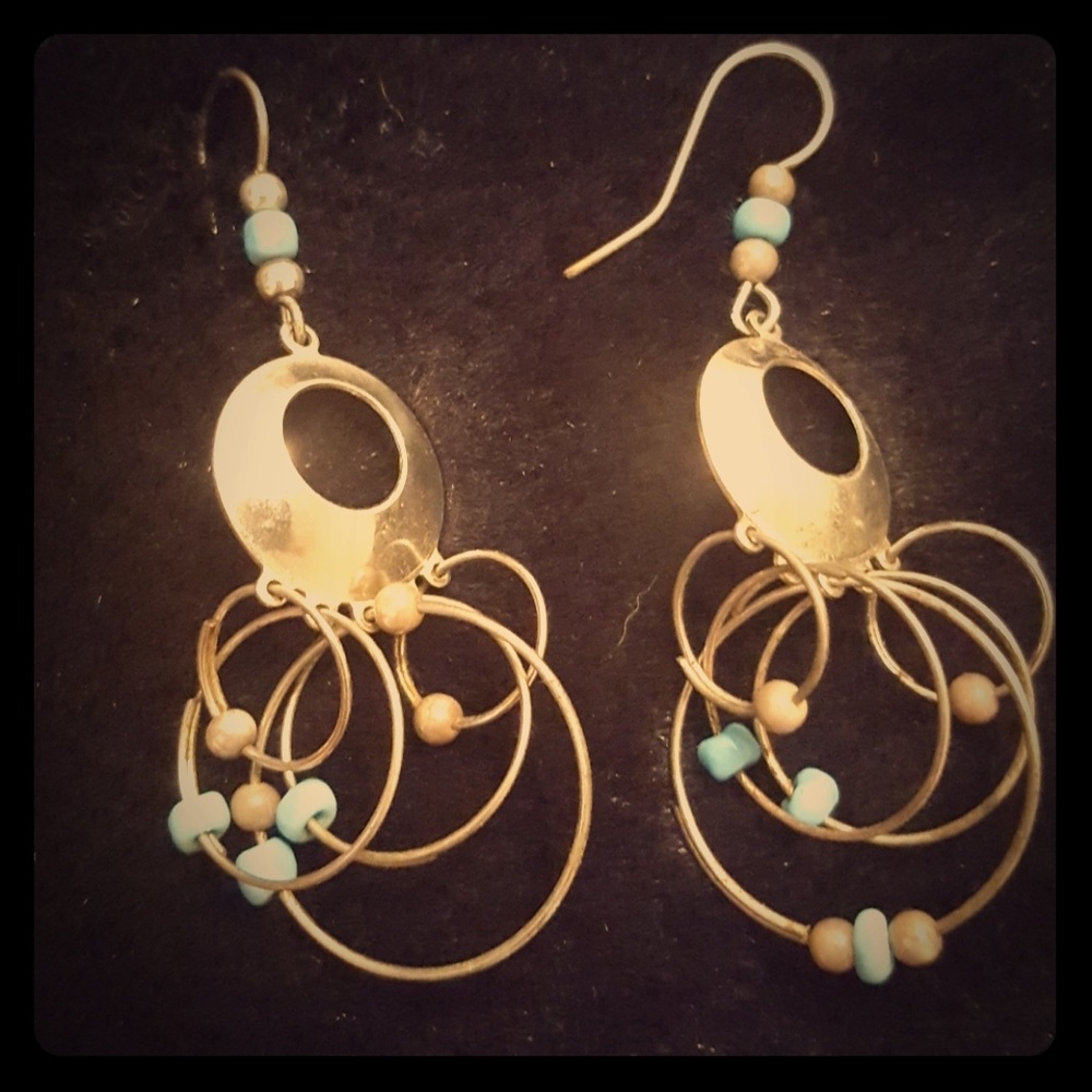 Dangly silver circle and hoop earrings.