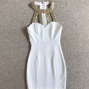 White dress with gold sequin detail at neckline