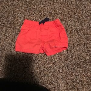 Orange outfit with a money on the shirt