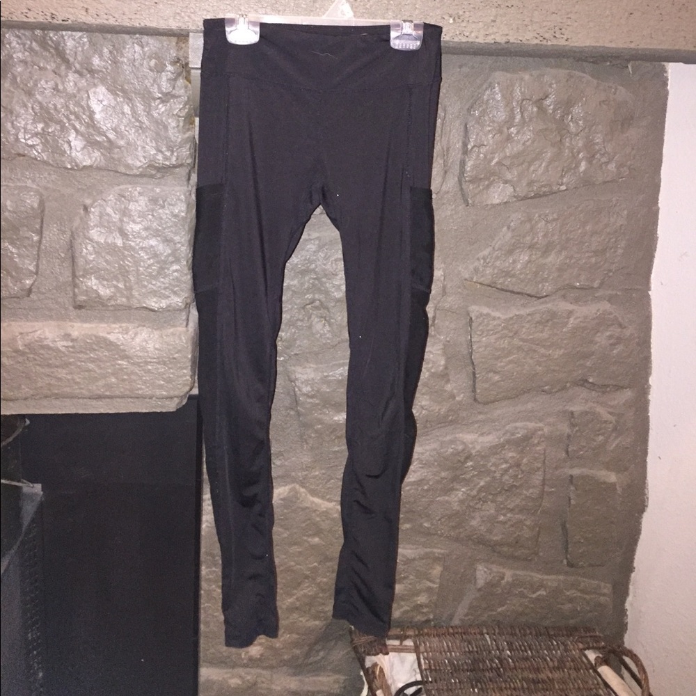Black workout leggings with pockets and mesh.