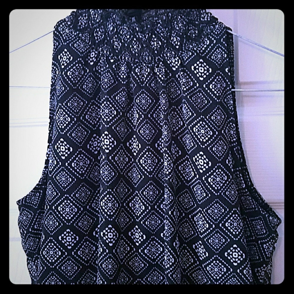 Sleeveless,  high neck  with little ruffle