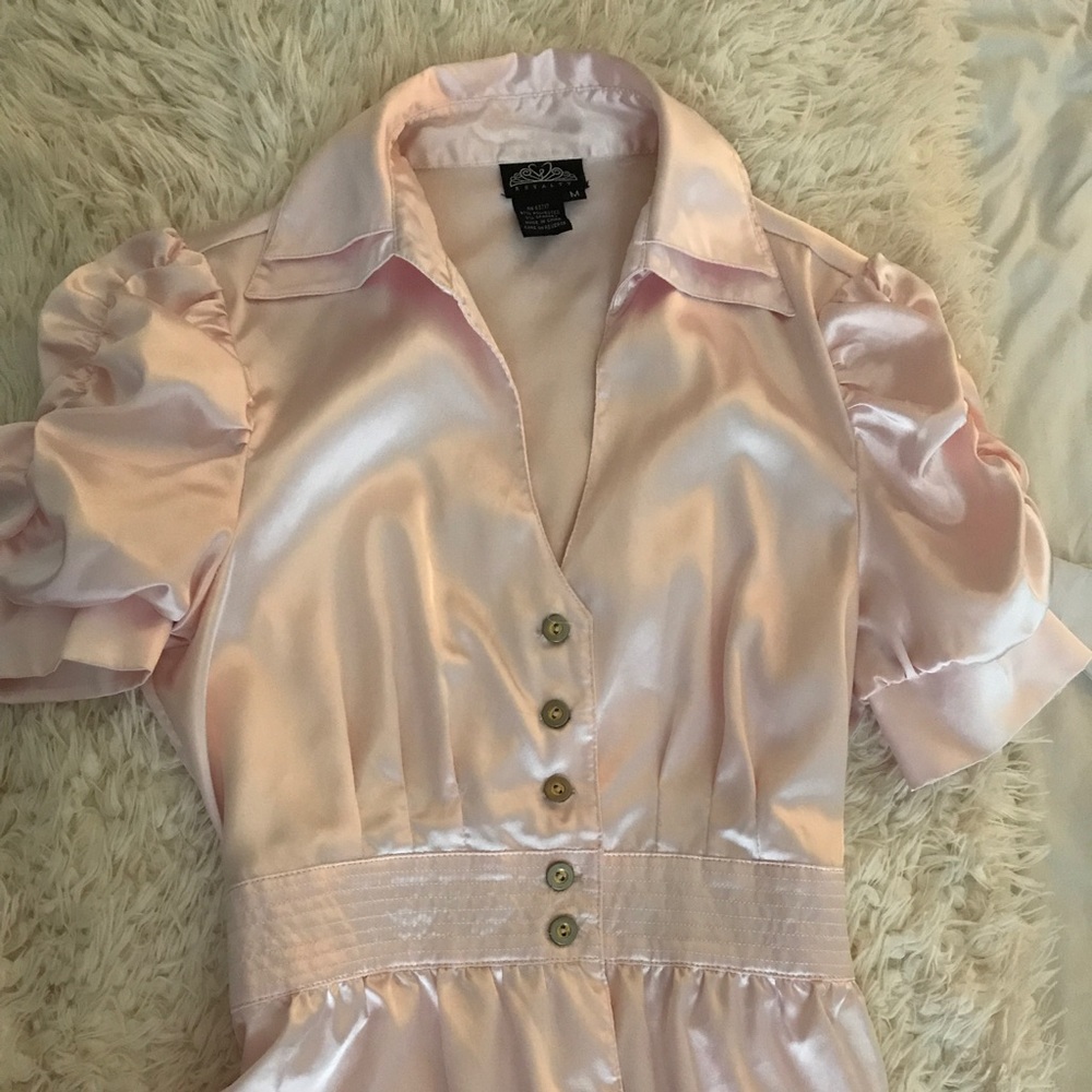 Light pink satin blouse.