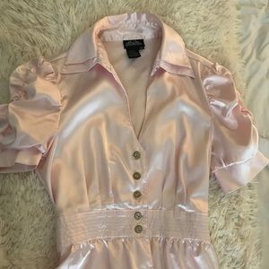 Light pink satin blouse.