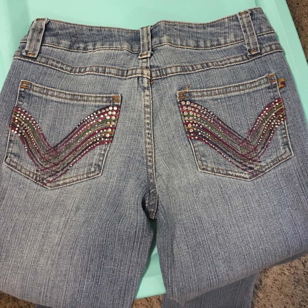 Size 3 jeans with designs on back pockets.