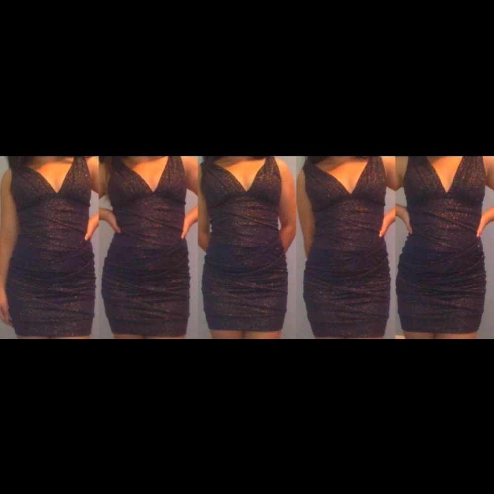 Dark blue short formfitting glitter dress.