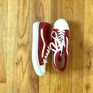 Old school red Vans with white streak on the side.