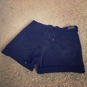 Rolled Levi's high-waisted black jean shorts